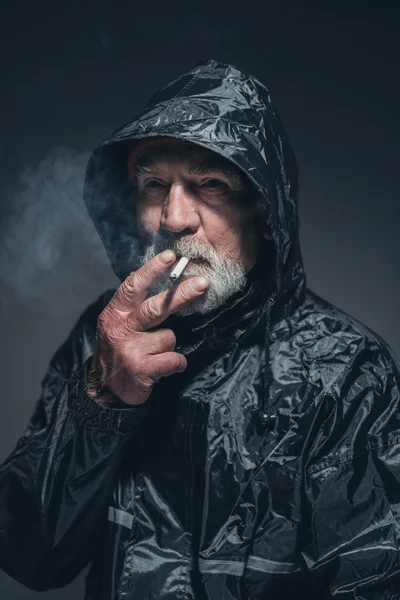 Thoughtful Senior Man in Rain Jacket