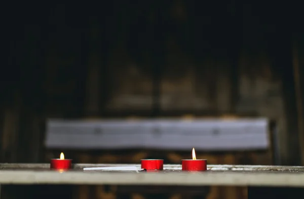 Three votive candles in a church