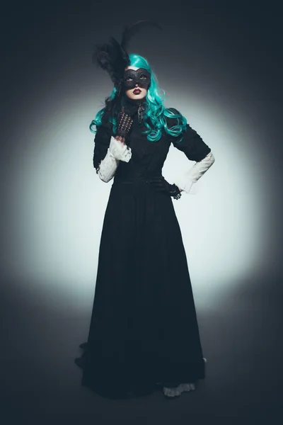 Woman in Vintage Gown with Dramatic Mask