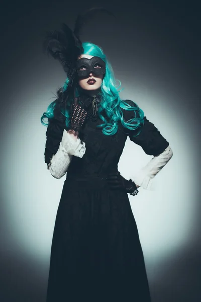 Woman in Vintage Gown with Dramatic Mask