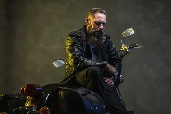 Bearded Biker Man Sitting on a Motorcycle