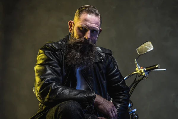 Bearded Biker Man Sitting on a Motorcycle