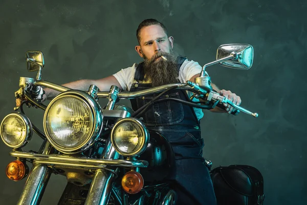 Bearded Man on his Motorcycle Smoking a Cigarette