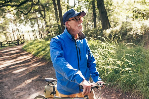 Senior man standing in forest