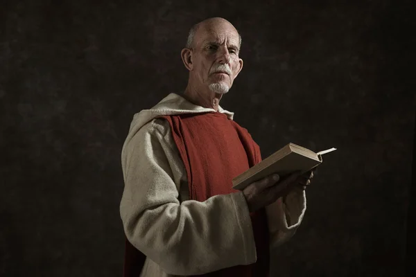 Official portrait of monk holding book.