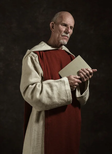 Official portrait of monk holding book.