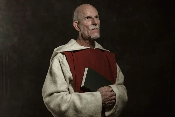 Official portrait of monastic holding book.