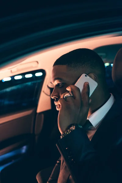 Businessman in car calling