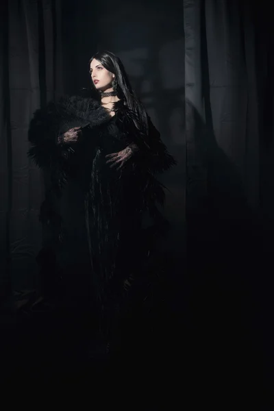 Dark mysterious witch fashion woman.