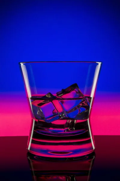 Drink in bar on color abstract background