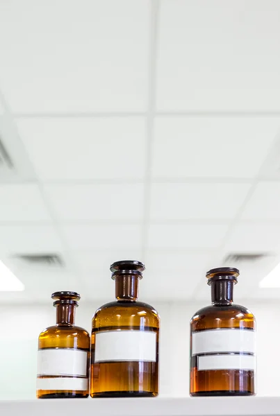 Medicine bottle with blank label on a shelf in the laboratory