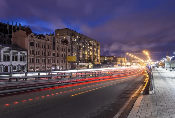 Car light trails and urban landscape. Moving car with blur light through city at night. Kiev city, Ukraine.