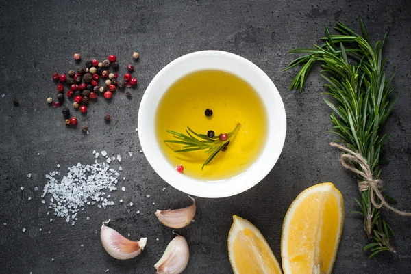 Black food background with olive oil and spices