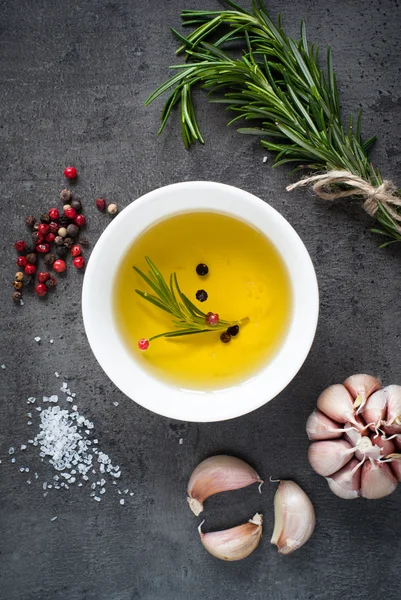 Black food background with olive oil and spices