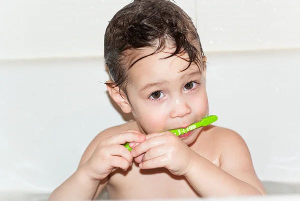 Little boy brush teeth.