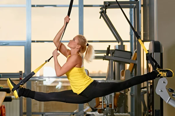 Woman does splits with trx fitness