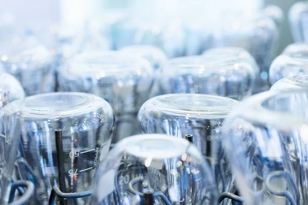 Flasks and test tubes set in the tray industrial dishwasher.