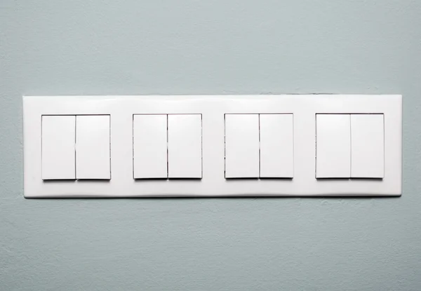 Close-up of multiple light switches on blue background