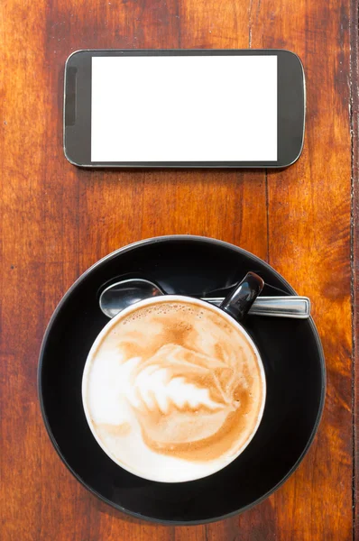 Up view of coffee smartphone with blank screen