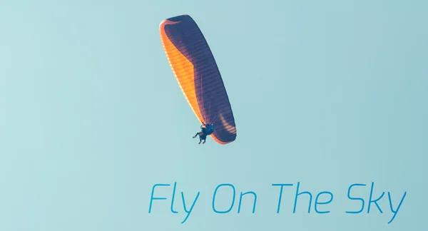 Paraglider in the sky with inspirational quote