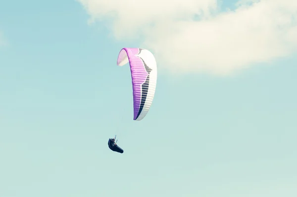 Paraglider making a turn up in the blue sky