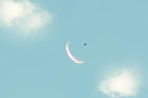 Paraglider in the sky making a loop