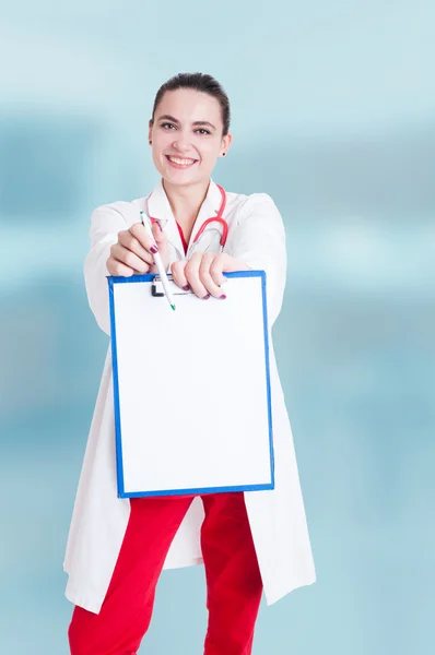 Successful medic holding blank clipboard paper