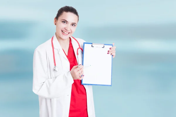 Pretty young female medic with empty clipboard