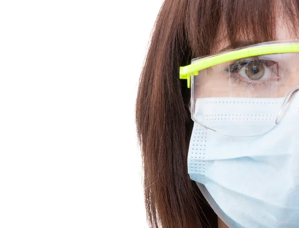 Half face of a dentist woman wearing protection glasses