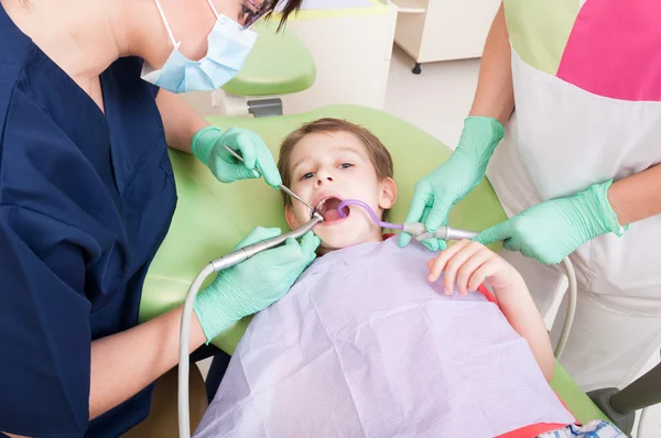 Child patient drilling procedure in dental office
