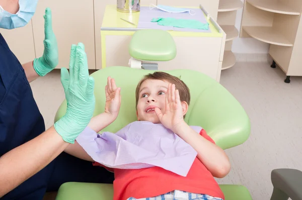 Woman doctor and kid patient playing clapping hands game