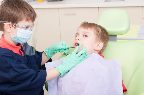 Kids playing in dentist office as doctor and patient