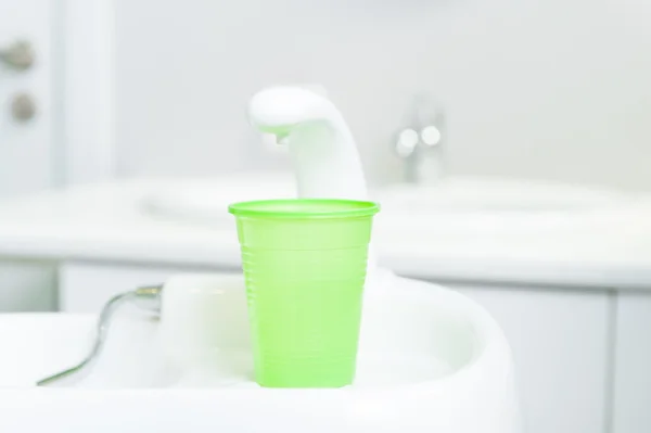 Plastic cup or glass of water in dental office