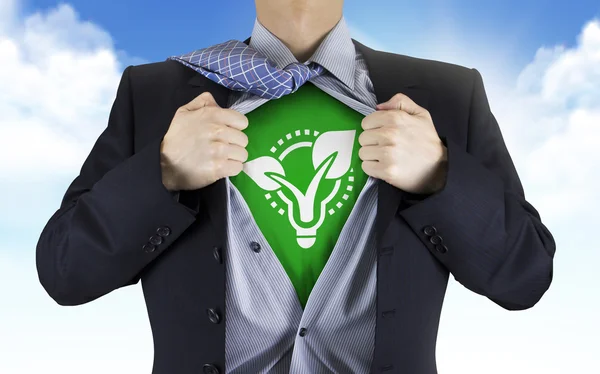 Businessman showing eco icon underneath his shirt