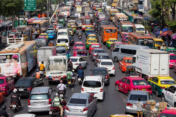 Traffic moves slowly along a busy road in Bangkok, Thailand.