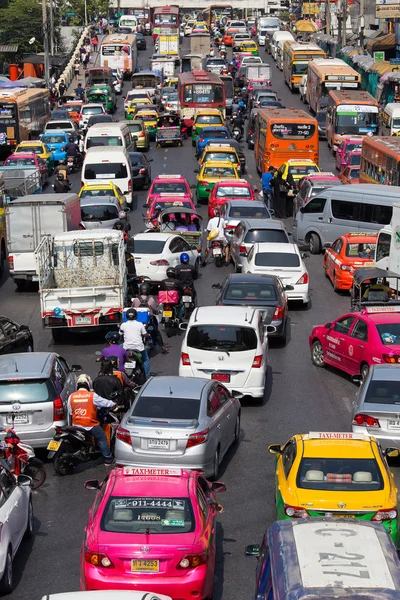 Traffic moves slowly along a busy road in Bangkok, Thailand.