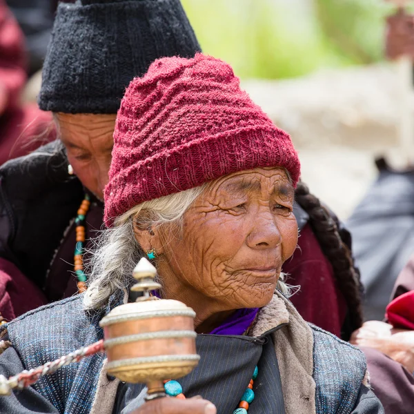 Tibetan old people during mystical mask dancing Tsam mystery dance in time of Yuru Kabgyat Buddhist festival at Lamayuru Gompa, Ladakh, North India