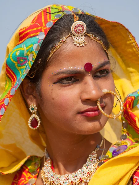 Indian girl in colorful ethnic attire at Pushkar Camel Mela in Rajasthan, India
