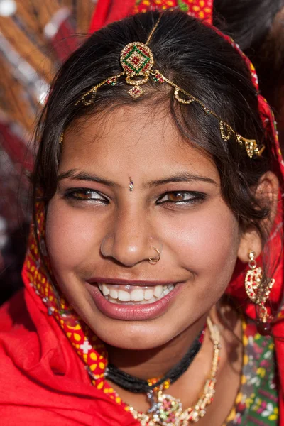 Indian girl in colorful ethnic attire at Pushkar Camel Mela in Rajasthan, India