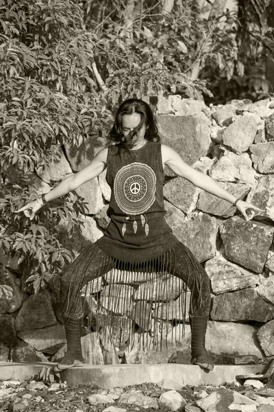 Young woman doing shamanic dance in nature.