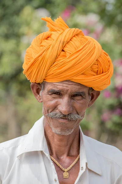 Indian man attended the Pushkar Camel Mela. This fair is the largest camel trading fair in the world.