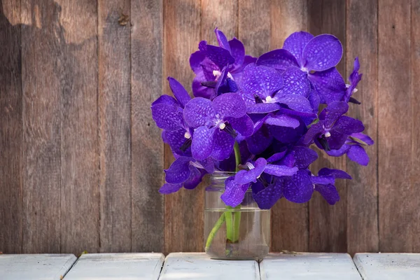 Beautiful bouquet of orchids flower on a wooden background