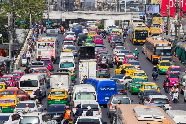 Traffic moves slowly along a busy road in Bangkok, Thailand.