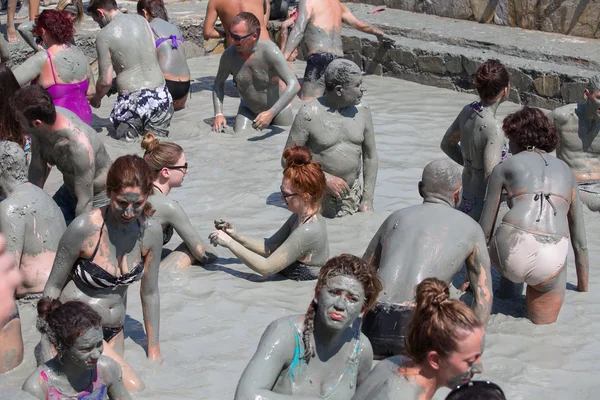 People in grey mud bath. Dalyan, Turkey