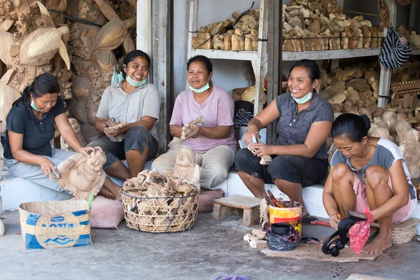 Indonesian women are making wooden souvenirs for tourist .Ubud, Bali. Indonesia