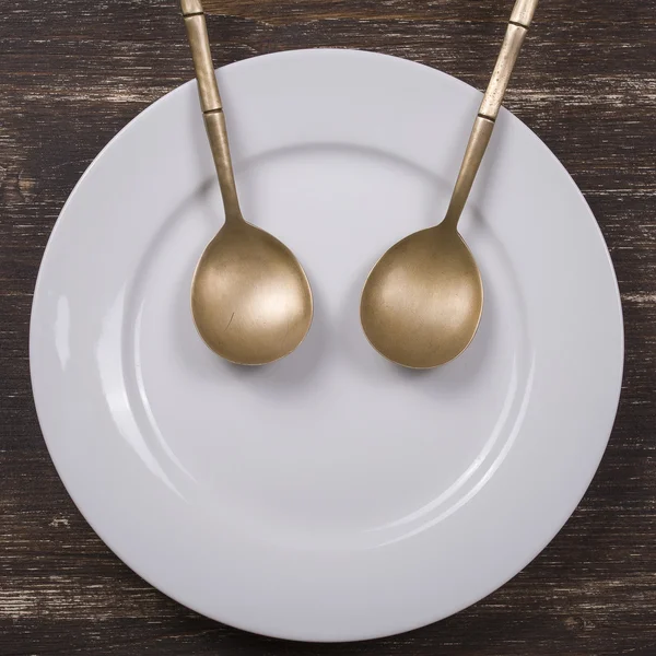 Facial image on the plate with spoons