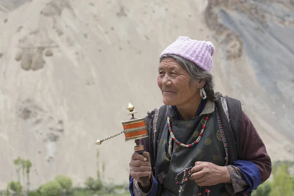 Tibetan old women during mystical mask dancing Tsam mystery dance in time of Yuru Kabgyat Buddhist festival at Lamayuru Gompa, Ladakh, North India