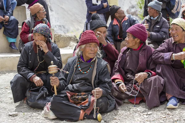 Tibetan old people during mystical mask dancing Tsam mystery dance in time of Yuru Kabgyat Buddhist festival at Lamayuru Gompa, Ladakh, North India