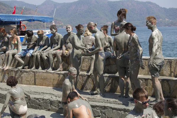 People are taking a mud bath. Mud baths are great for the skin. Dalyan, Turkey