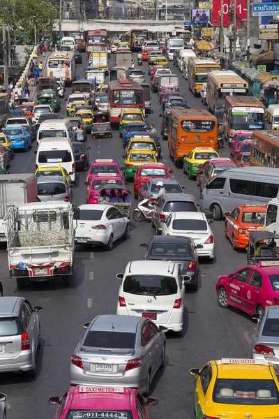 Traffic moves slowly along a busy road in Bangkok, Thailand.